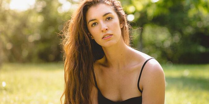 A woman wearing a black camisole dress