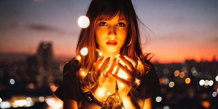 Woman holding fireflies
